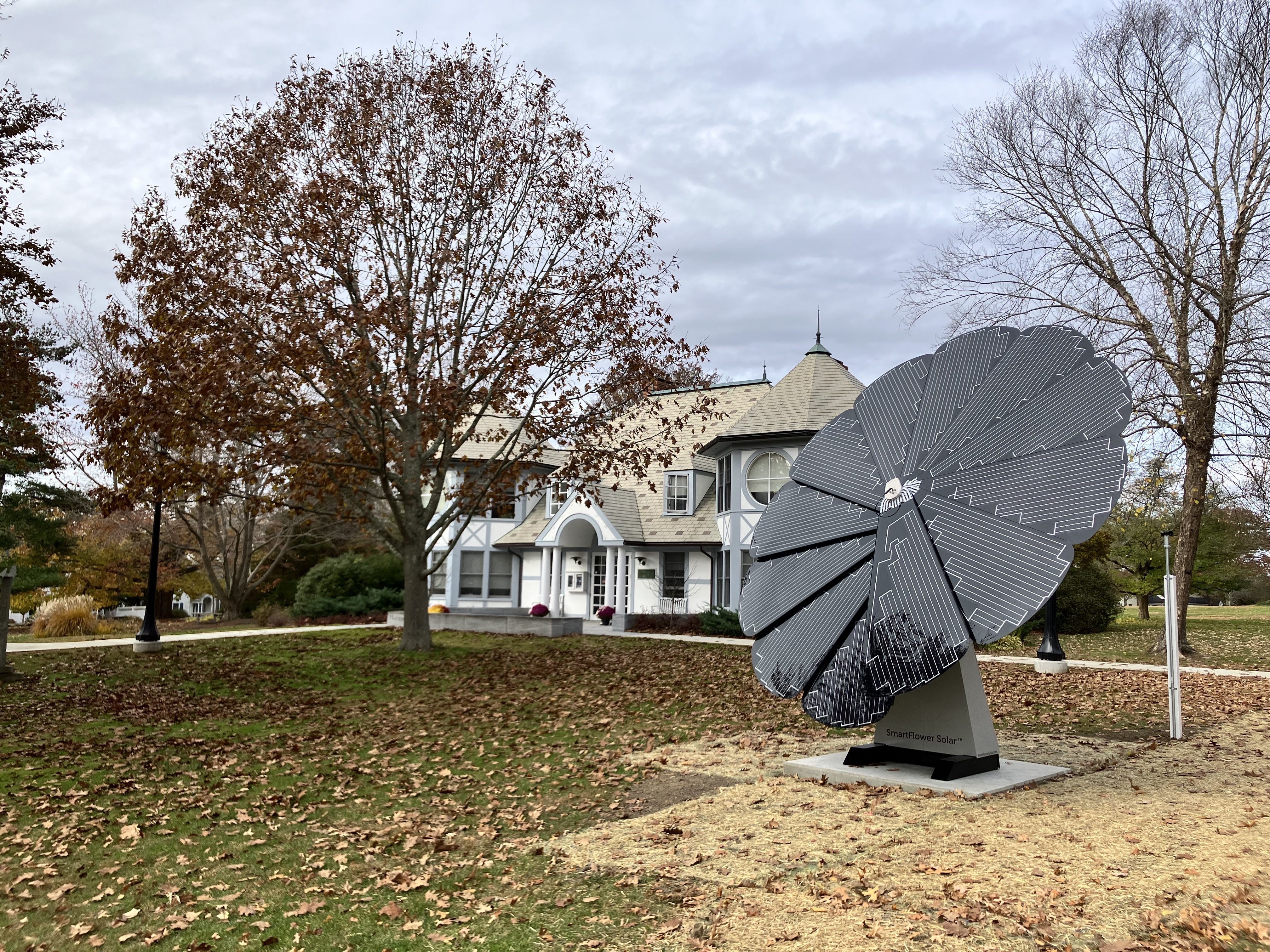 Energy-efficient SmartFlower installation enhancing sustainability near classic-style house