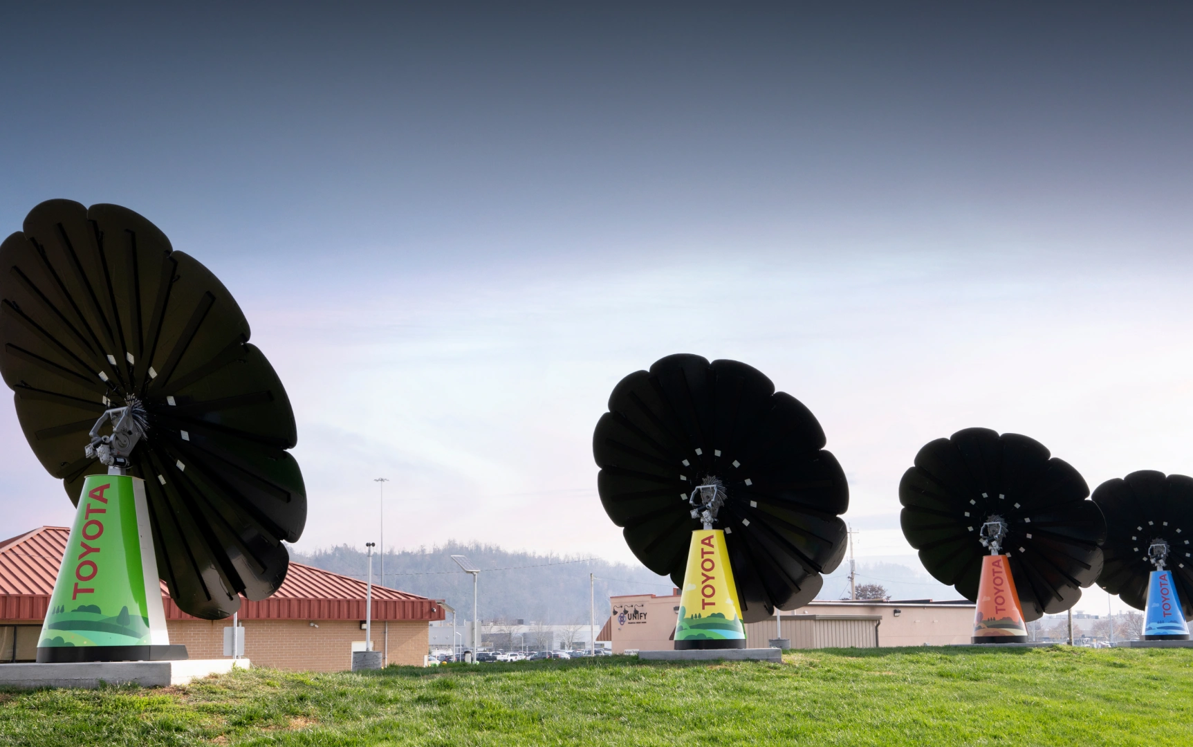 Black petal solar SmartFlowers near car dealership promoting eco-conscious branding and green energy use