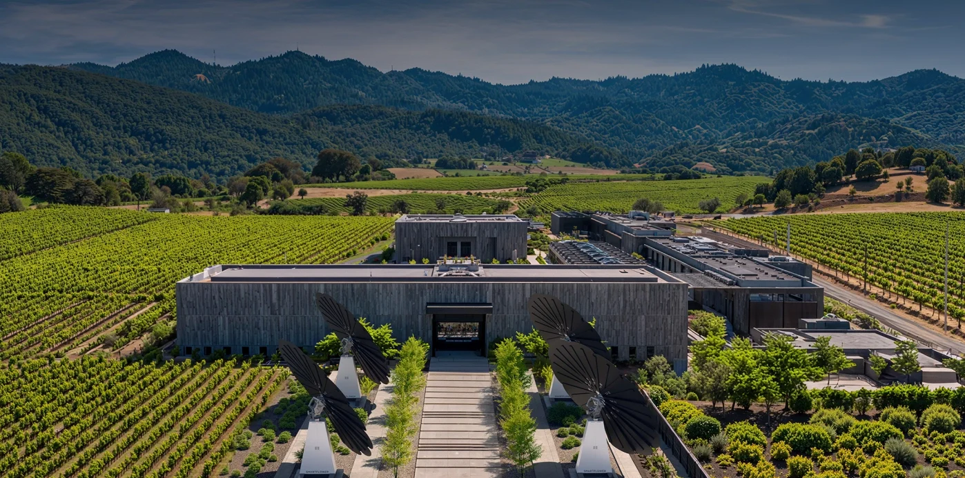 Aerial view of vineyard estate with SmartFlower solar panels and modern winery buildings in foreground