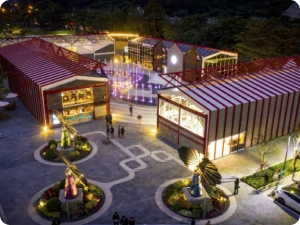 Illuminated public square featuring SmartFlower installations and interactive fountain with festive ambiance