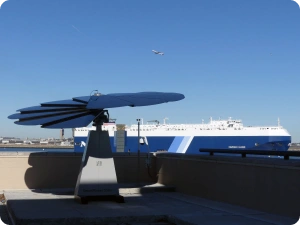 Coastal solar energy installation highlighting sustainable energy near busy maritime shipping terminal
