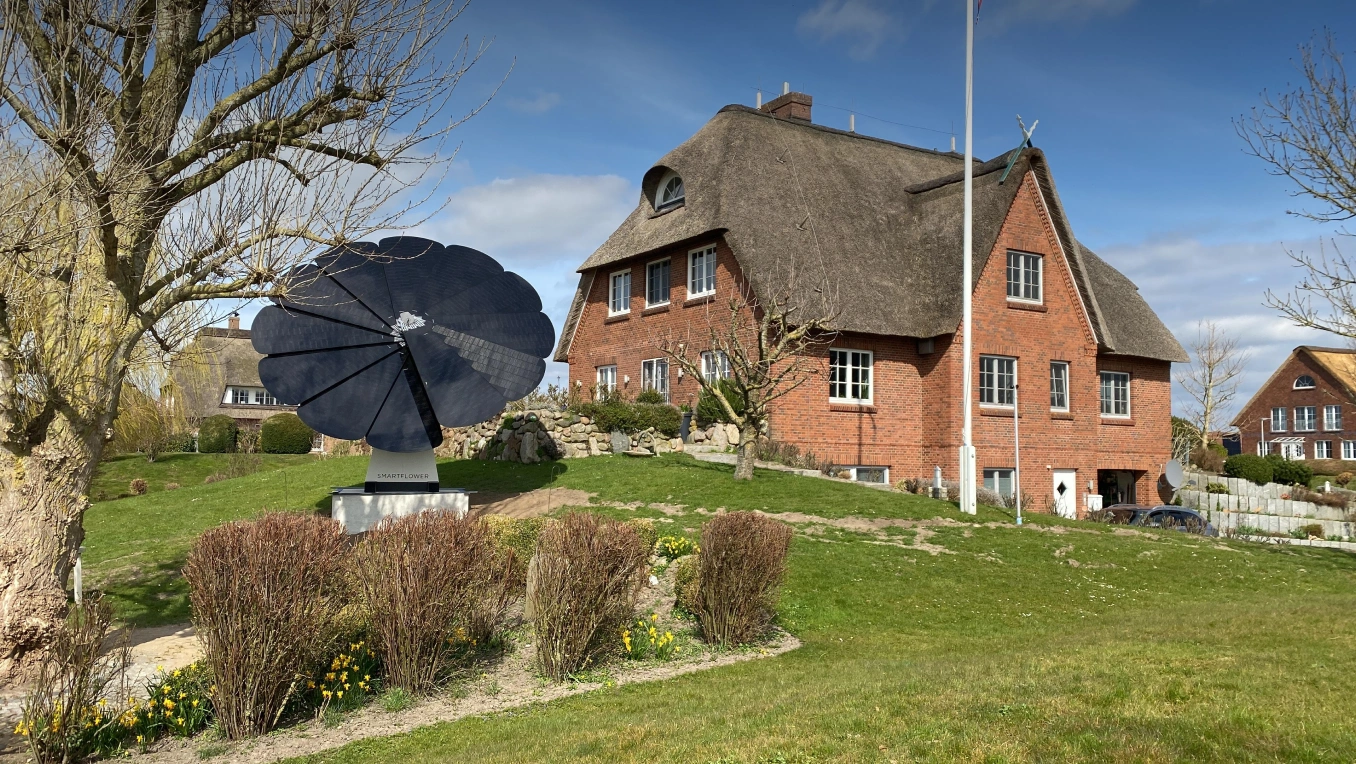SmartFlower solar panel installed in the yard of a traditional countryside home