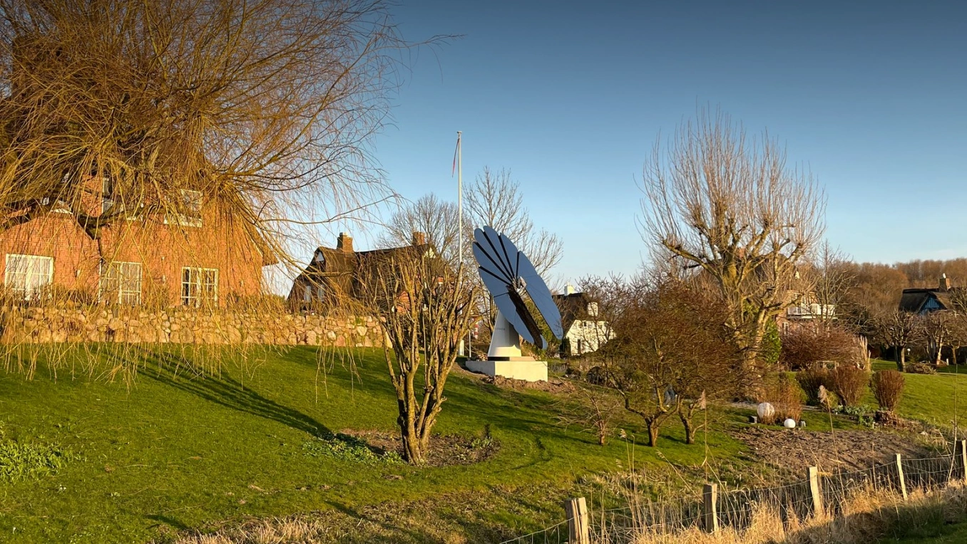 SmartFlower solar panel set in a peaceful rural landscape at golden hour