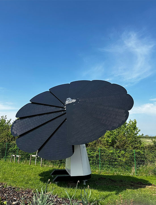 Standalone SmartFlower solar unit capturing sunlight in a rural landscape