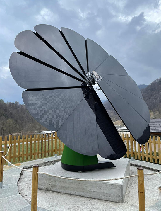 Flower-shaped solar energy system in a scenic hillside parking area on a cloudy day