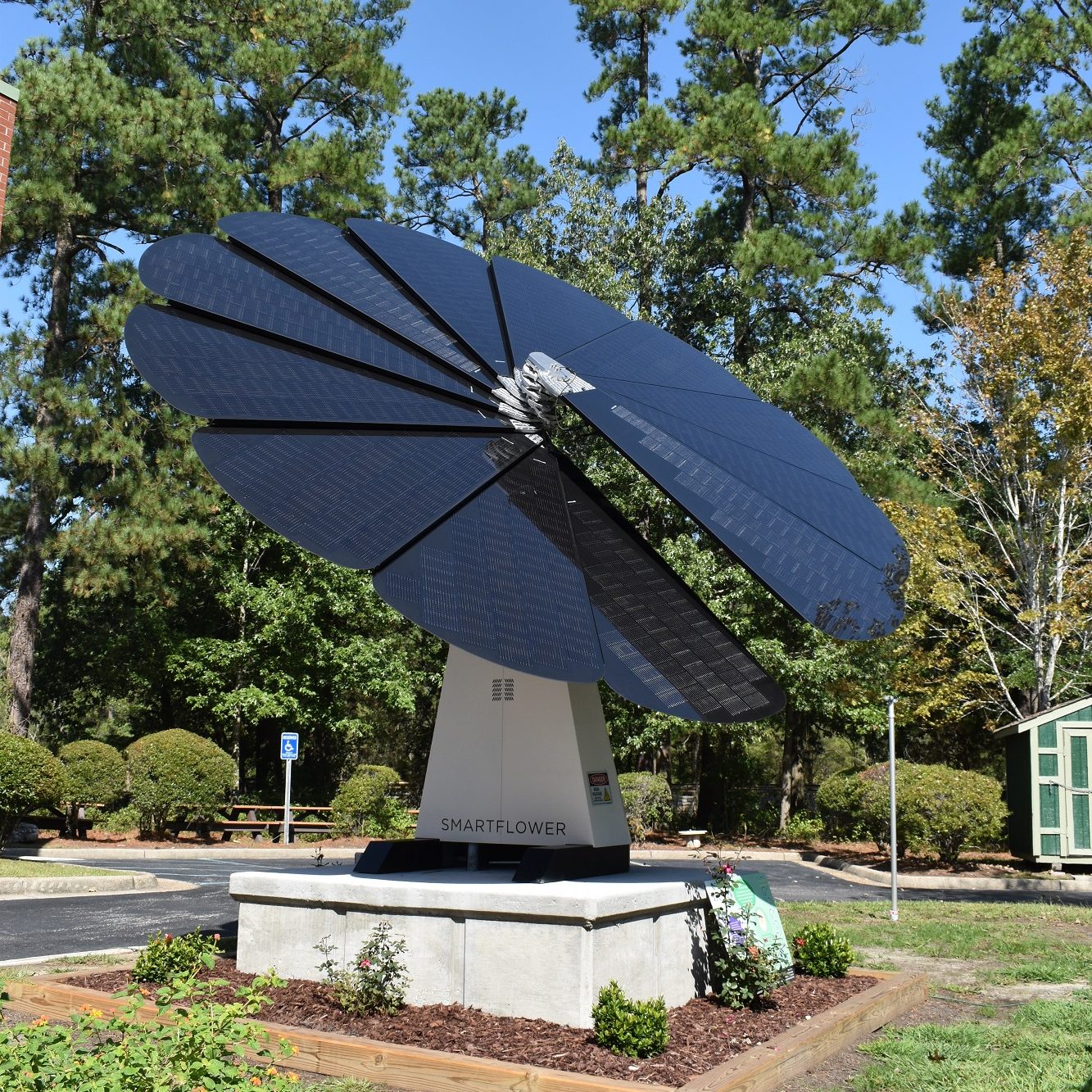 SmartFlower sitting on top of a square concrete platform at the Girls Scouts Colonial Coast.