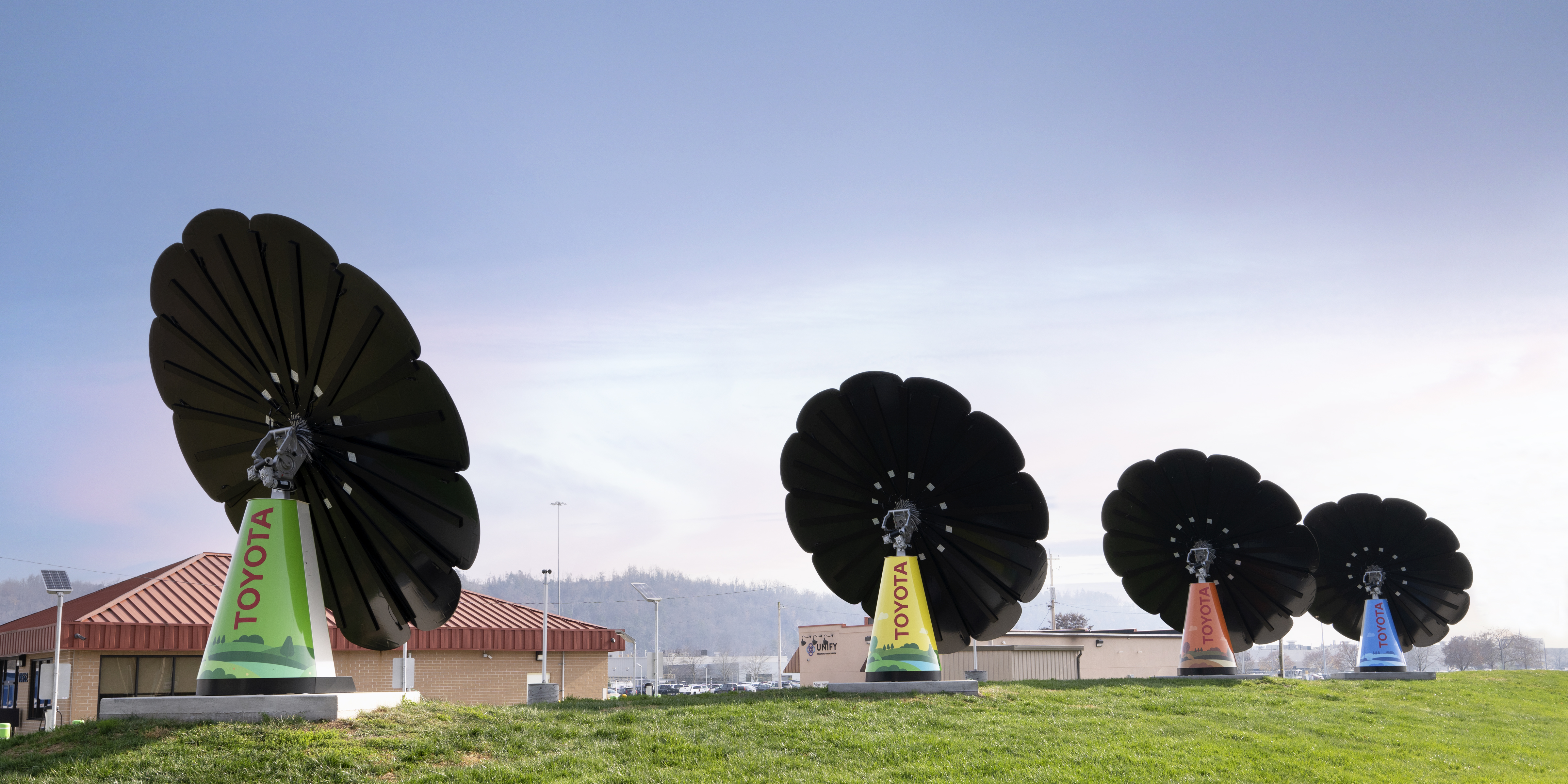 Four SmartFlowers sitting on a vast green landscape at Toyota West Virgina